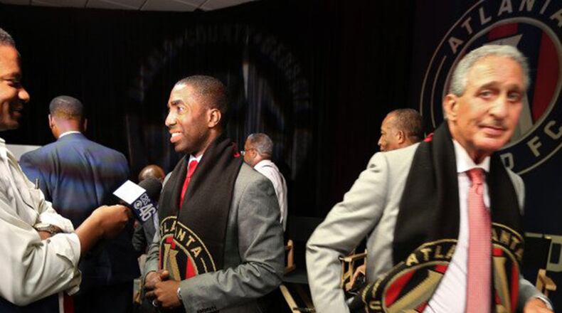 Lee May, center, and Atlanta United soccer team owner Arthur Blank, right.  The team will build its practice facility behind the DeKalb County jail  because nothing says “New Downtown DeKalb” like a practice soccer field behind a jail.