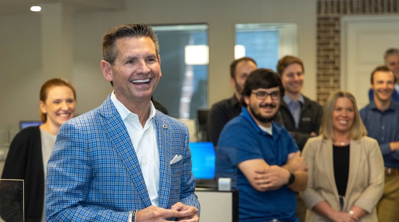 Pat Flood shares a laugh during a group meeting at Supreme Lending in Alpharetta for the Top Workplace medium sized business. PHIL SKINNER FOR THE ATLANTA JOURNAL-CONSTITUTION