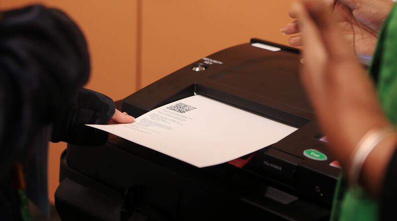 Theresa Carrington (right) assists a woman who wished not to be name (left) cast her ballot during the mock election for Fulton County on Tuesday, February 18, 2020, at the Roswell Library in Roswell, Georgia.  Fulton County held a mock election to test out its new voting machines and system. (Christina Matacotta for the Atlanta Journal-Constitution)