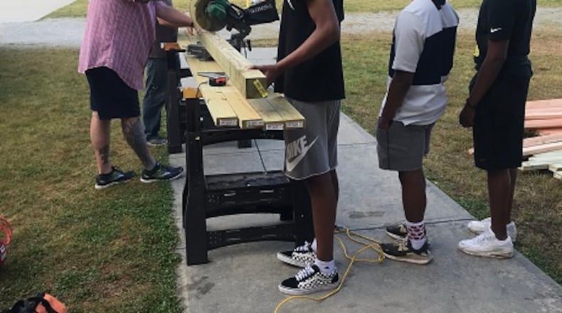 Archer High engineering students help build a chicken coop for Lovin Elementary. The joint project allows students at both schools to experience STEM curriculum. COURTESY OF GWINNETT COUNTY PUBLIC SCHOOLS