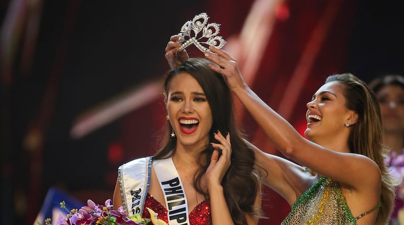Catriona Gray of the Philippines, left, reacts with joy as she is crowned the Miss Universe 2018 by Miss Universe 2017 Demi-Leigh Nel-Peters during the final round of the 67th Miss Universe competition in Bangkok, Thailand, Monday, Dec. 17, 2018.(AP Photo/Gemunu Amarasinghe)