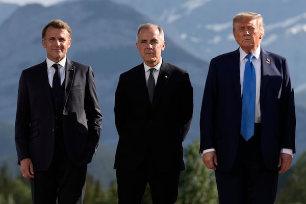 From left, France's President Emmanuel Macron, Canada's Prime Minister Mark Carney and President Donald Trump, pose during a group photo at the G7 Summit, Monday, June 16, 2025, in Kananaskis, Canada. (AP Photo/Mark Schiefelbein)