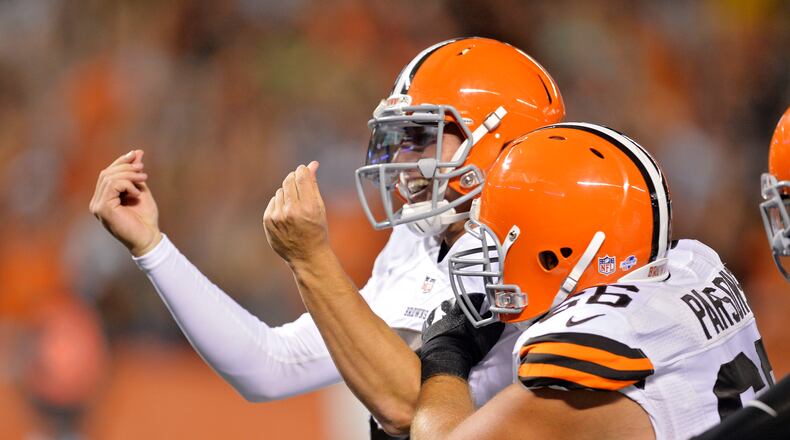 FILE - In this Aug. 23, 2014, file photo, Cleveland Browns quarterback Johnny Manziel celebrates after a 7-yard touchdown run against the St. Louis Rams in the third quarter of a preseason NFL football game, in Cleveland. The Browns have released troublesome quarterback Johnny Manziel. The team cut ties on Friday, March 11, 2016, with the 2012 Heisman Trophy winner after two disappointing, drama-filled seasons. Manziel faces an uncertain future in the NFL and potential criminal charges in Texas following a domestic violence incident. (AP Photo/David Richard, File)