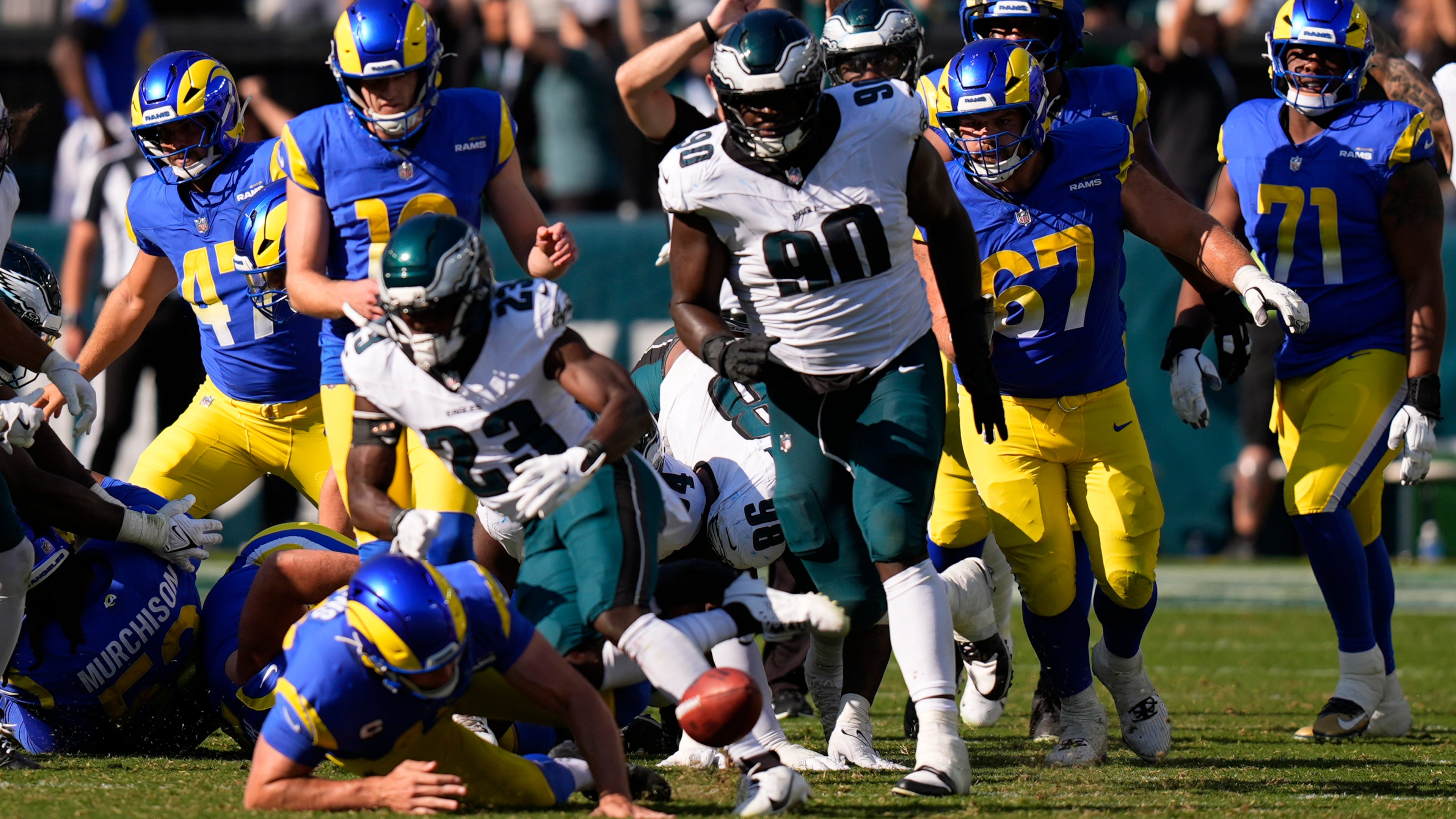 Philadelphia Eagles defensive tackle Jordan Davis (90) blocks a field goal attempt by Los Angeles Rams kicker Joshua Karty (16) before running the ball back for a touchdown as time expires during the second half of an NFL football game against the Los Angeles Rams Sunday, Sept. 21, 2025, in Philadelphia. (AP Photo/Chris Szagola)