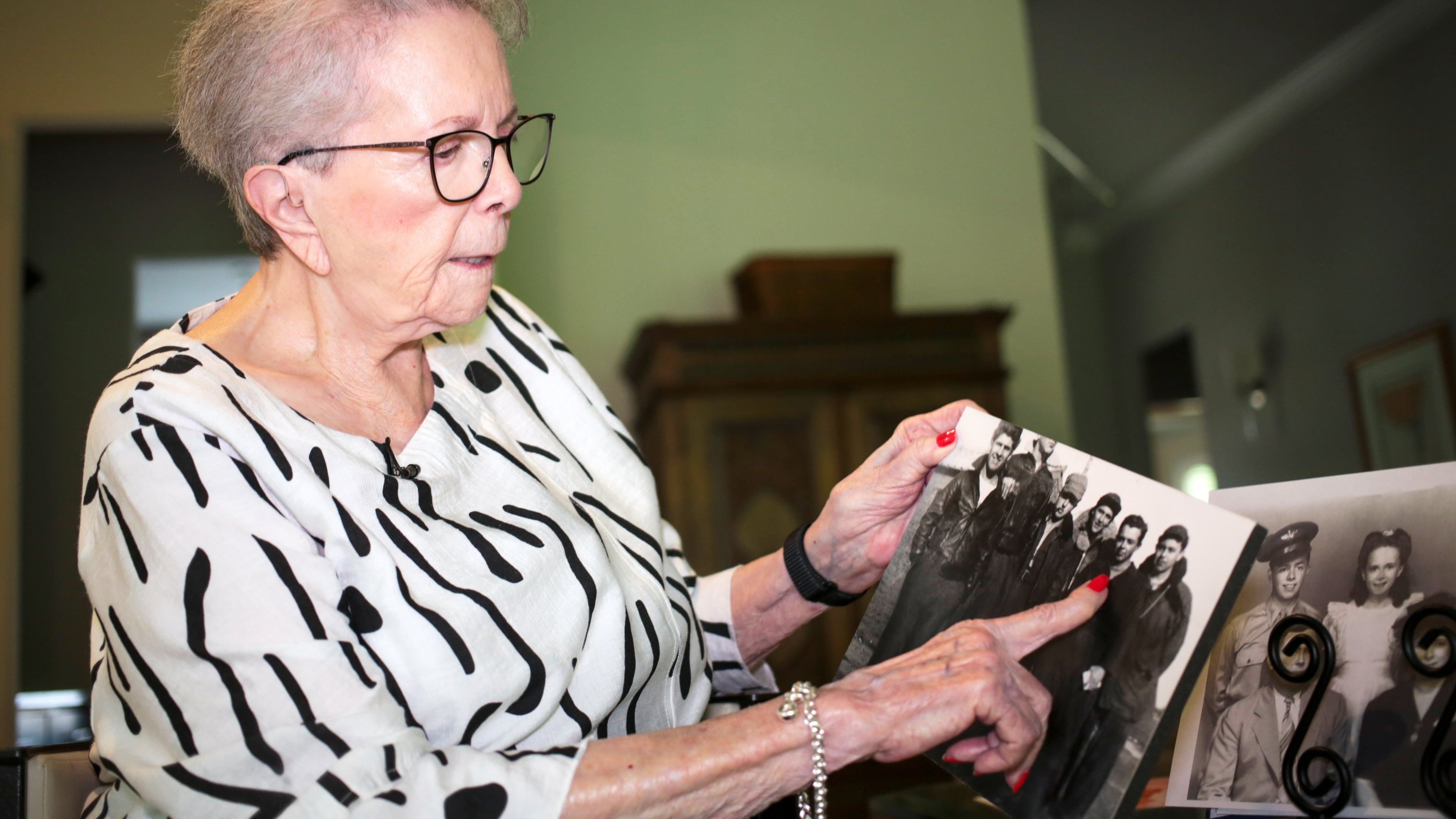 June West Brandt, 93, holds a photo displaying her brother, William Durham West Jr., who was killed in World War II, Aug. 27, 2025, in Richmond, Texas. (AP Photo/Lekan Oyekanmi)