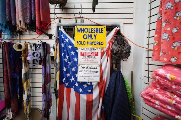FILE - An American flag hangs in a store owned by Kyung Sook Im in the Toy District of Los Angeles, Wednesday, April 9, 2025, where the majority of the merchandise is imported from China. (AP Photo/Jae C. Hong, File)