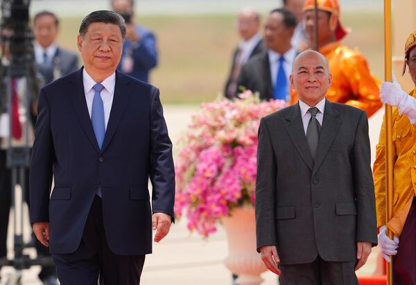 In this photo released by Agence Kampuchea Press (AKP), Cambodia's King Norodom Sihamoni, right, and Chinese President Xi Jingping attend a welcome ceremony at Phnom Penh International Airport in Phnom Penh, Cambodia, Thursday, April 17, 2025. (AKP via AP)