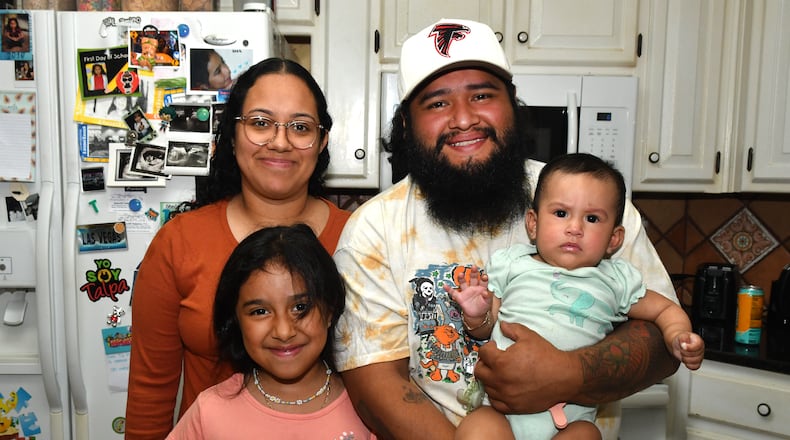 Kimball House executive chef Arturo Justo poses his wife, Cindy Justo, and daughters, Mia (7) and Suzie (8 months), in their Lawrenceville home. (CHRIS HUNT FOR THE ATLANTA JOURNAL-CONSTITUTION)