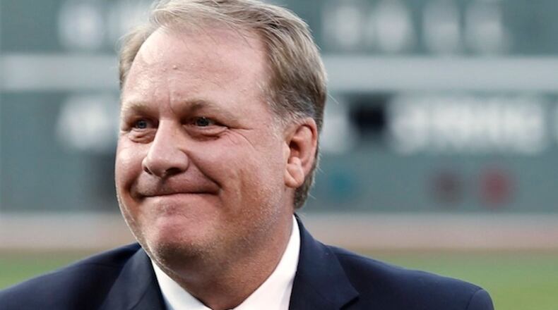 FILE In this Aug. 3, 2012, file photo, former Boston Red Sox pitcher Curt Schilling reacts after being introduced as a new member of the Boston Red Sox Hall of Fame, at Fenway Park in Boston. ESPN says commentator Schilling won't appear on the air for the next month in the wake of his anti-Muslim tweet. ESPN said Thursday, Sept. 3, 2015, that Schilling won't be on telecasts for the rest of the regular season or the American League wild-card game on Oct. 6. The former star pitcher and "Sunday Night Baseball" analyst was pulled by ESPN from a major league game and the network's coverage of the Little League World Series last month after he retweeted a post that compared Muslim extremists and Nazis. (AP Photo/Winslow Townson, File)