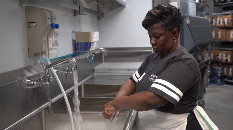 Antonia Thomas gets cleaned up for work at West Nest, where she works at the new Falcons stadium. Thomas said Westside Works gave her a new lease on life. Contributed