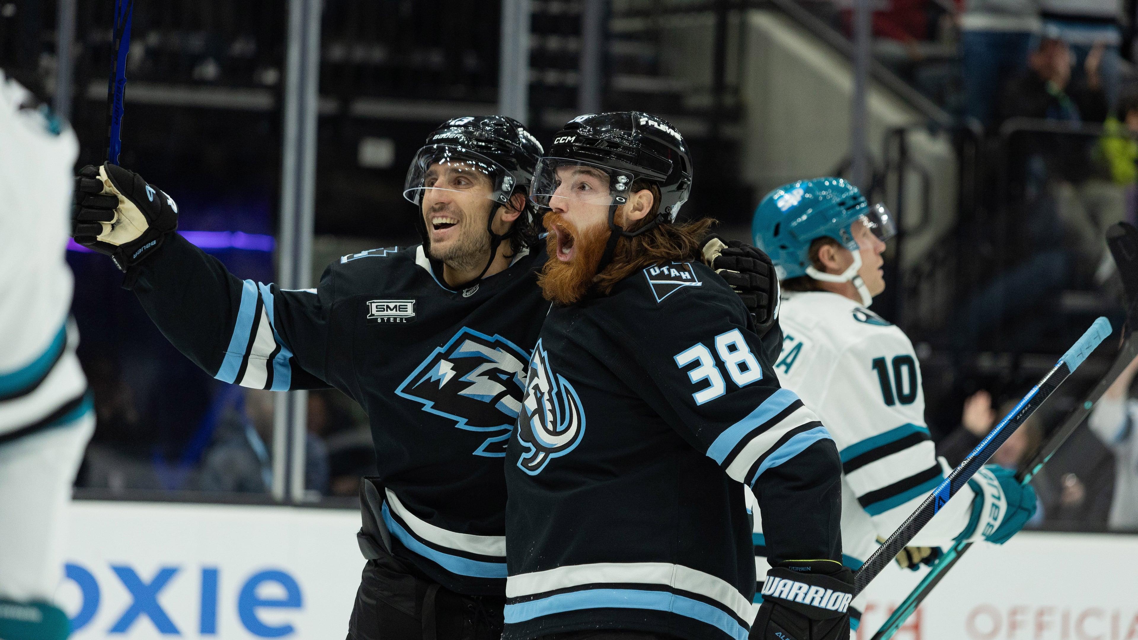 Utah Mammoth center Liam O'Brien (38) celebrates the goal with left wing Brandon Tanev (13) against San Jose Sharks during the second period of an NHL hockey game Friday, Oct. 17, 2025, in Salt Lake City. (AP Photo/Melissa Majchrzak)