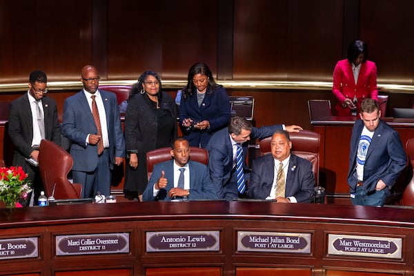 Council members look on as opponents of the under-construction law enforcement training center disrupt the City Council meeting last September. (Arvin Temkar / AJC)