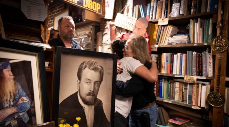 Friends of the late Dent Myers greet Marjorie Lyon, who worked with "Wildman" for more than 35 years. Lyon plans to keep the shop open Tuesdays through Saturdays, saying "It's what Dent wanted, and I do my best to honor him." (Courtesy of Robin Rayne)