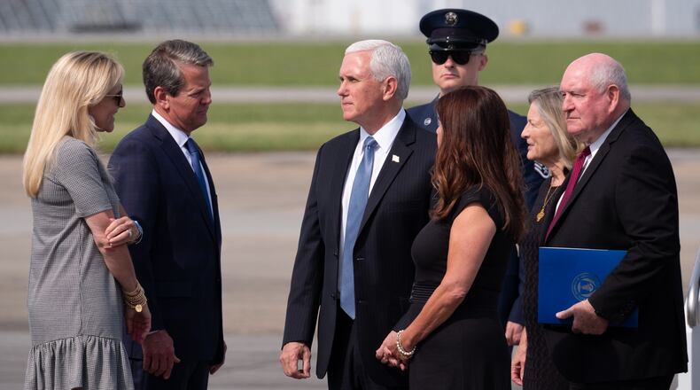 Vice President Mike Pence and his wife, Karen, speak with Gov. Brian Kemp and his wife, Marty, as Secretary of Agriculture Sonny Perdue and his wife, Mary, stand behind them after arriving at Dobbins Air Reserve Base in Marietta on Friday.Ben Gray for The Atlanta Journal-Constitution