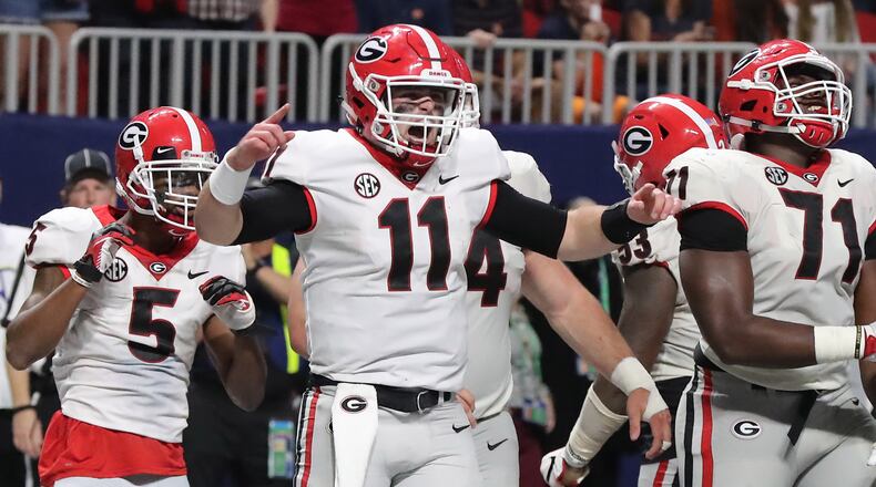 Bulldogs quarterback Jake Fromm (11) celebrates a late touchdown over Auburn during Saturday's SEC Championship Game. (Curtis Compton / ccompton@ajc.com)