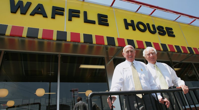 In this file photo taken July 26, 2005, Waffle House founders Joe Rogers Sr. (left) and Tom Forkner pose in front of a Waffle House restaurant in Norcross after eating lunch there. AP PHOTO / RIC FELD, FILE