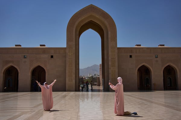 Tourists take photos at the Sultan Qaboos Grand Mosque in Muscat, Oman, Saturday, April 12, 2025. (AP Photo/ Fatima Shbair)