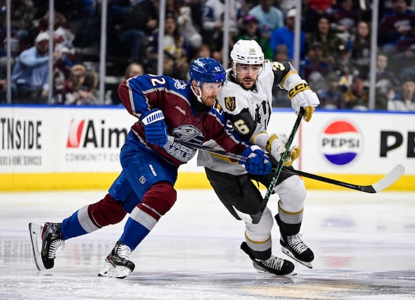 Colorado Eagles forward Gabriel Landeskog, left, battles for position with Henderson Silver Knights forward Raphael Lavoie in the first period of a minor league hockey game Friday, April 11, 2025, in Loveland, Colo. (Andy Cross/The Denver Post via AP)