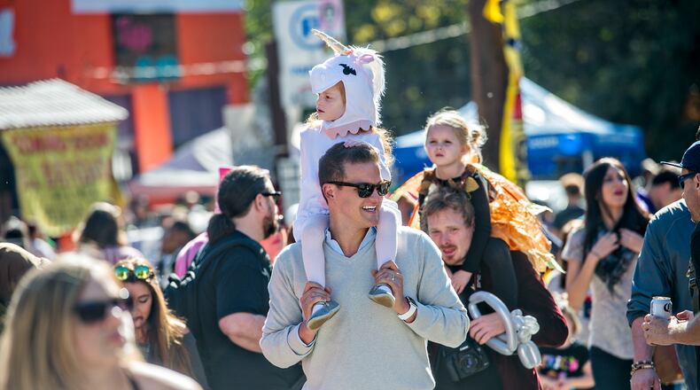 October 17, 2015 Atlanta - Monet Aouad (center) rides on her father Robert's shoulders as they look for a spot to watch the Little Five Points Halloween Parade in Atlanta on Saturday, October 17, 2015. The annual parade brought out tens of thousands of people to watch the antics. JONATHAN PHILLIPS / SPECIAL