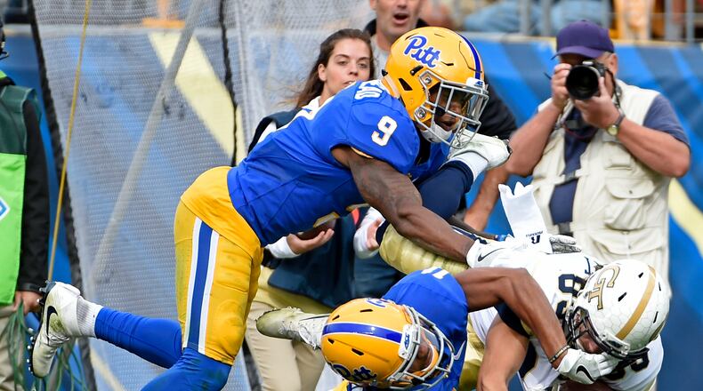 Pittsburgh defensive backs Jordan Whitehead (9) and Dane Jackson (11) tackle Georgia Tech wide receiver Brad Stewart (83) after a pass completion during the second half of an NCAA college football game in Pittsburgh, Saturday, Oct. 8, 2016. (AP Photo/Fred Vuich)