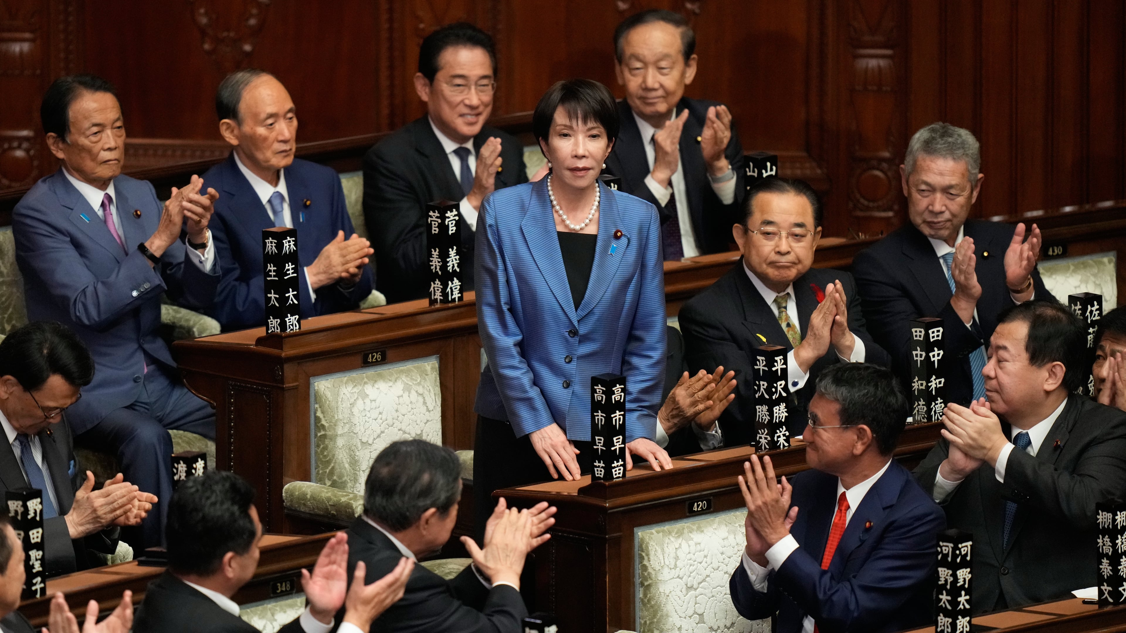 Lawmakers applaud as Sanae Takaichi, center, is elected as Japan's new prime minister during the extraordinary session of the lower house, in Tokyo, Japan, Tuesday, Oct. 21, 2025.(AP Photo/Eugene Hoshiko)