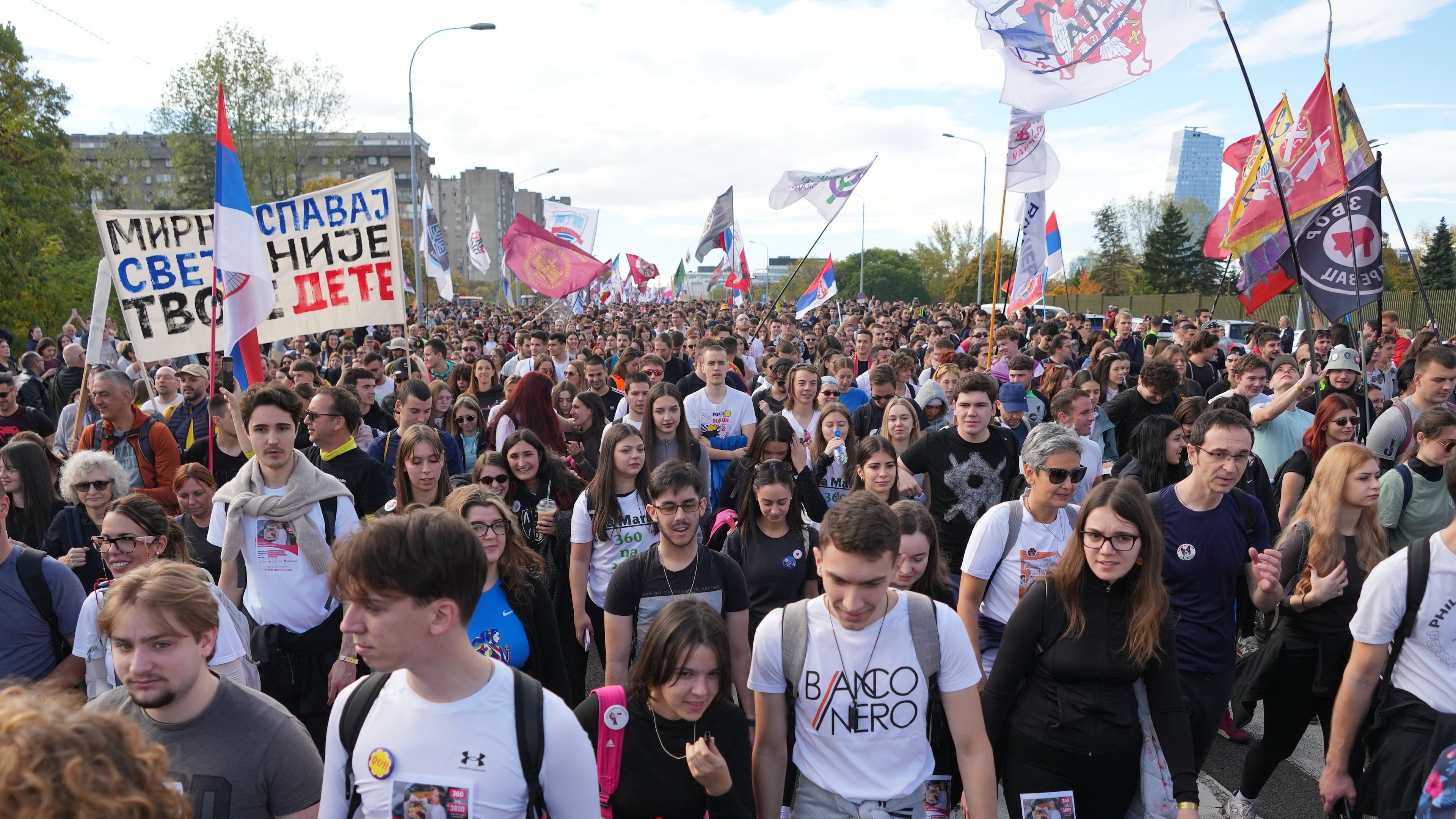 People gather, among them students, to walk on the street towards the northern city of Novi Sad, for a huge rally on Nov. 1 marking the first anniversary of a train station disaster that killed 16 people, in Belgrade, Serbia, Thursday, Oct. 30, 2025. (AP Photo/Darko Vojinovic)
