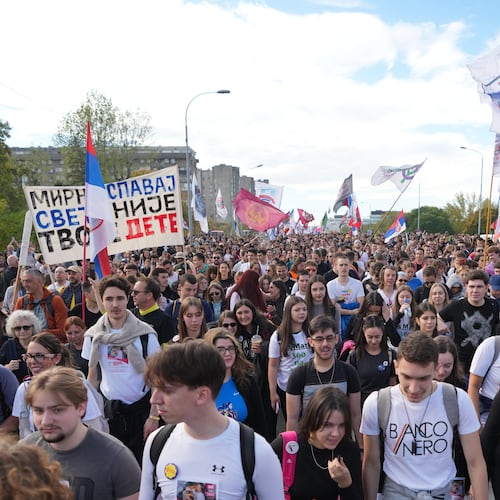 People gather, among them students, to walk on the street towards the northern city of Novi Sad, for a huge rally on Nov. 1 marking the first anniversary of a train station disaster that killed 16 people, in Belgrade, Serbia, Thursday, Oct. 30, 2025. (AP Photo/Darko Vojinovic)