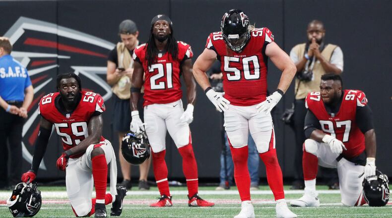 Falcons linebacker De'Vondre Campbell (59), defensive back Desmond Trufant (21), defensive end Brooks Reed (50) and defensive tackle Grady Jarrett (97) react after the Saints scored an apparent touchdown to win in OT on Sept. 23. It was ruled short of the goal line but the Saints went on to score on the next play. BOB ANDRES /BANDRES@AJC.COM