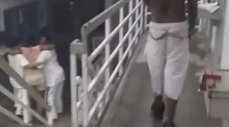 In a screen shot from Facebook video purportedly taken early Sunday morning at Ware State Prison, inmates help one of their own who was hurt in a riot.