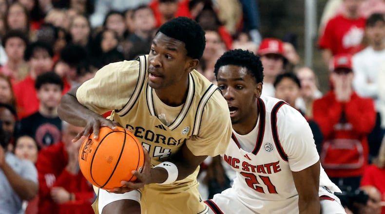 Georgia Tech's Kowacie Reeves Jr. (14) battles for the ball with North Carolina State's Terrance Arceneaux (21) during the first half of an NCAA college basketball game in Raleigh, N.C., Saturday, Jan. 17, 2026. (AP Photo/Karl DeBlaker)