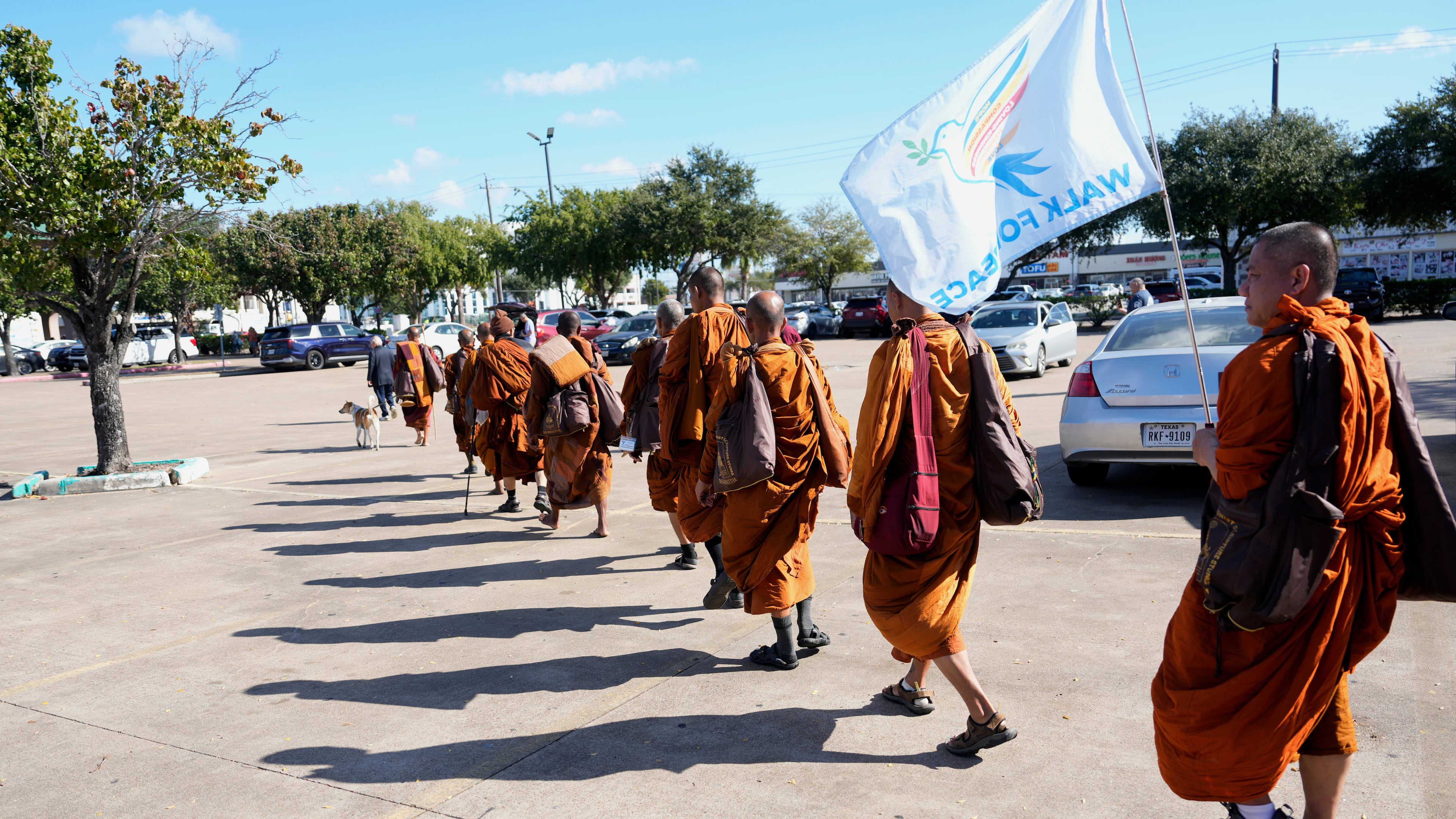 The Buddhist monks from the Huong Dao Vipassana Bhavana Center in Fort Worth, who are undertaking a 2,300 mile pilgrimage of "Walk for Peace," arrive for a welcome ceremony at Hong Kong City Mall in Houston, Friday, Nov. 14, 2025. (Melissa Phillip/Houston Chronicle via AP)