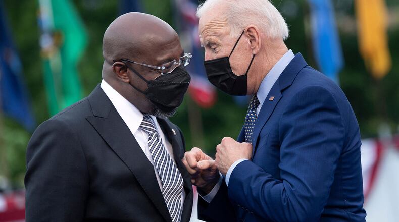President Joe Biden, right, said he hopes to have a decision by the end of the week on whether to suspend the federal gas tax of 18 cents a gallon. U.S. Sen. Raphael Warnock has been among the biggest supporters seeking a federal gas tax holiday as a way to ease inflation. (Brendan Smialowski/AFP via Getty Images/TNS)