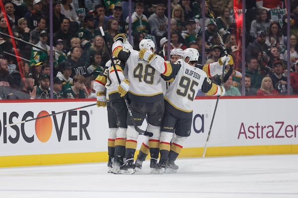 Vegas Golden Knights defenseman Shea Theodore (27) celebrates with teammates after scoring a power play goal during the first period of Game 6 of a first-round NHL hockey playoff series against the Minnesota Wild, Thursday, May 1, 2025, in St. Paul, Minn. (AP Photo/Bailey Hillesheim)