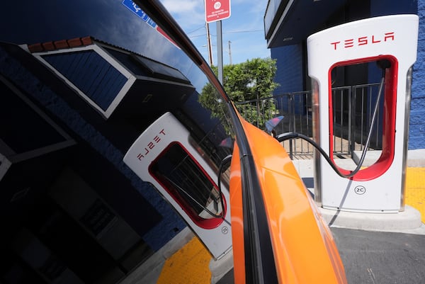 FILE - An electric vehicle charges at a station May 22, 2025, in Long Beach, Calif. (AP Photo/Damian Dovarganes, File)