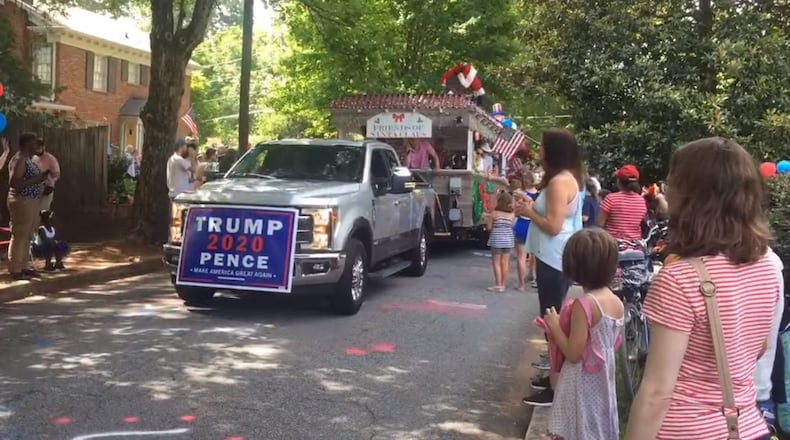 Officials say this sign was not OK'd to appear in the Fourth of July parade. (Screenshot via YouTube / user Dances with Goofy)
