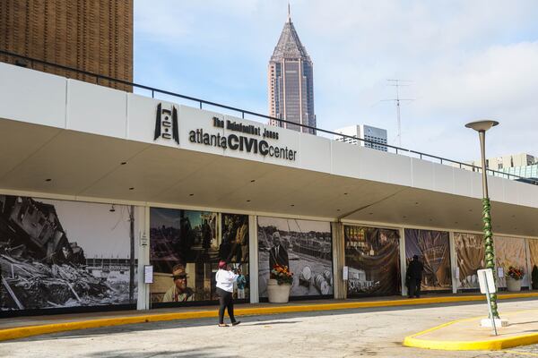A woman walks by the Civic Center before the redevelopment groundbreaking cermony on Tuesday. (Abbey Cutrer/AJC)