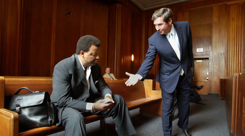 In 2005, inside a Massachusetts courtroom, Hawks General Manager Billy Knight, left, refuses to shake hands with Steve Belkin as members of the Atlanta Spirit fought for legal control of the team. (AP Photo/Bizuayehu Tesfaye)