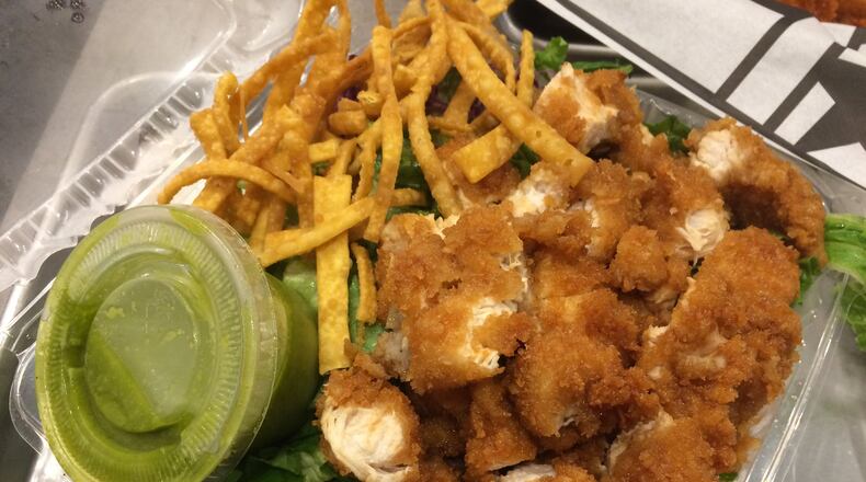 Ponko Chicken’s meal-size salad comes with choice of protein and dressing and is shown here with chopped original chicken tenders and the walnut-cilantro salad. CONTRIBUTED BY WENDELL BROCK