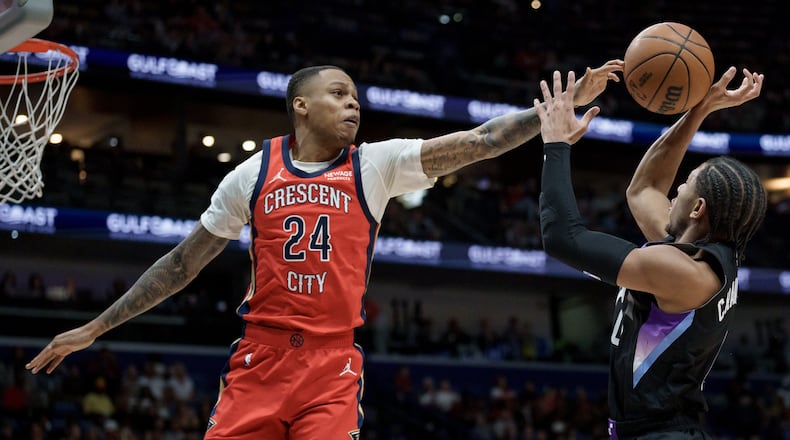 FILE - New Orleans Pelicans guard Jordan Hawkins (24) blocks the shot of Utah Jazz guard Kennedy Chandler (0) during the first half of an NBA basketball game in New Orleans, April 7, 2026. (AP Photo/Matthew Hinton, File)