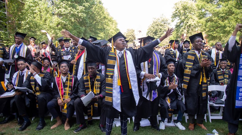 Graduates react after hearing billionaire Robert F. Smith is paying all student debt for the Class of 2019 during the Morehouse College graduation ceremony in Atlanta on Sunday, May 19, 2019. STEVE SCHAEFER / SPECIAL TO THE AJC