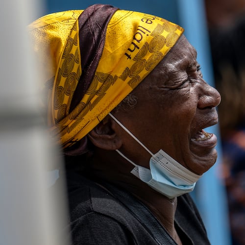 A woman mourns her child, who died of Ebola, at the General Hospital in Bunia, Congo, Thursday, May 21, 2026. (AP Photo/Moses Sawasawa)