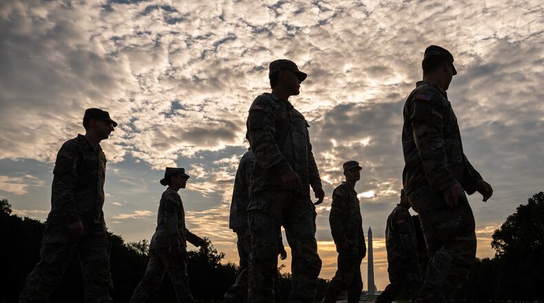 Members of the National Guard walk past the Lincoln Memorial Reflecting Pool before the March on Washington, Friday, Aug. 28, 2026, in Washington. (AP Photo/Julia Demaree Nikhinson)
