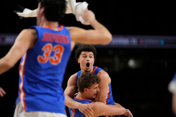 Florida guard Walter Clayton Jr. and center Micah Handlogten celebrates after their win against the Houston in the national championship at the Final Four of the NCAA college basketball tournament, Monday, April 7, 2025, in San Antonio. (AP Photo/Brynn Anderson)