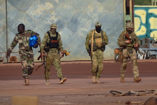 FILE - This undated photograph handed out by the French military shows three Russian mercenaries, right, in northern Mali. (French Army via AP)