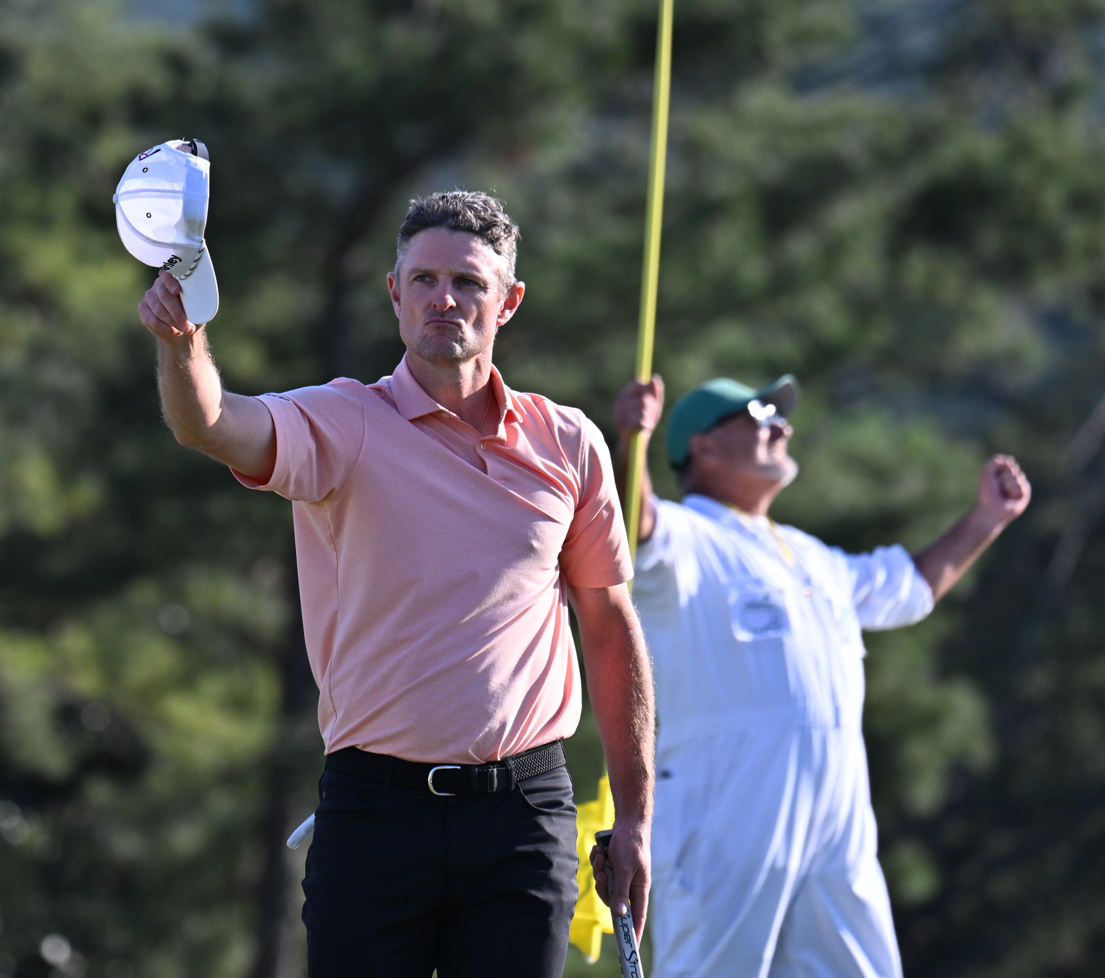 Justin Rose and his caddie Mark Fulcher celebrate his birdie putt on 18th hole during final round of the Masters golf tournament, at Augusta National Golf Club, Sunday, April 13, 2025, in Augusta, Ga. (Hyosub Shin / AJC)