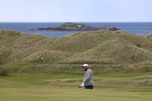 Scottie Scheffler of the United States plays onto the 16th green during a practice round for the 2025 British Open golf championship at the Royal Portrush Golf Club, Northern Ireland, Monday, July 14, 2025. (AP Photo/Peter Morrison)