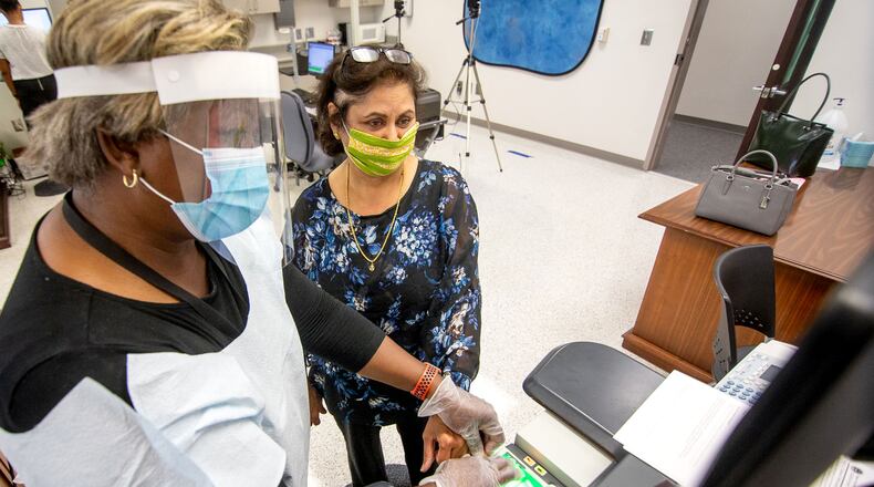 Usha Malhotia (R) gets her fingerprints taken during orientation for substitute teachers at the J. Alvin Wilbanks Instructional Support Center in Suwanee on July 2. Gwinnett County schools have pushed to have all teacher vacancies filled by July 20. STEVE SCHAEFER FOR THE ATLANTA JOURNAL-CONSTITUTION