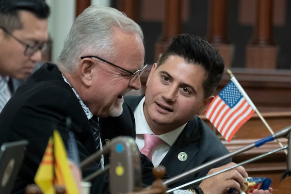 FILE - Republican Assembly members Tom Lackey, of Palmdale, left, and Bill Essayli, of Riverside, huddle at the Capitol in Sacramento, Calif., July 10, 2023. (AP Photo/Rich Pedroncelli, File)