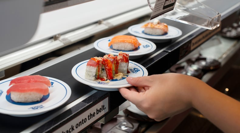 Sushi comes to customers on a conveyor belt at Kura Revolving Sushi. / Courtesy of Kura Revolving Sushi