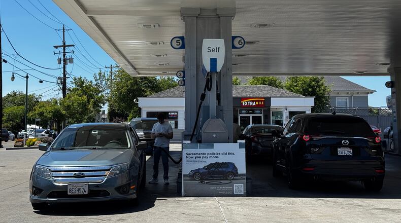 A sign blaming Sacramento policies for high gas prices is displayed at a Chevron gas station in Alameda, Calif., on Thursday, May 21, 2026. (AP Photo/Terry Chea)